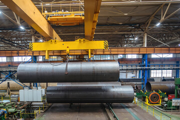 Finished pipe transportation by overhead crane in pipe factory