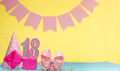 Date of birth for a girl  18. Copy space. Birthday in pink shades with a yellow background....