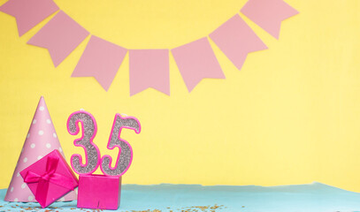 Date of birth for a girl  35. Copy space. Birthday in pink shades with a yellow background....