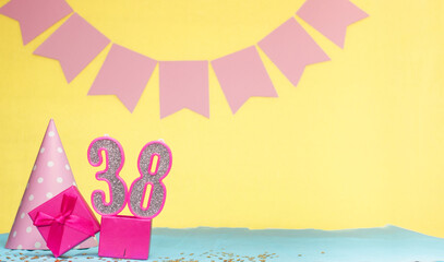 Date of birth for a girl  38. Copy space. Birthday in pink shades with a yellow background....