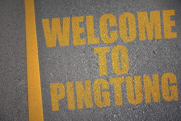 asphalt road with text welcome to Pingtung near yellow line.