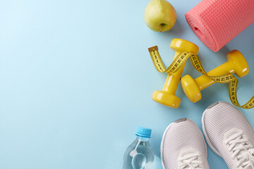Seasonal shape-up: fitness plans for a stronger you. Top view photo of white sneakers, yellow dumbbells, measure tape, yoga mat, apple, water on pastel blue background with marketing zone