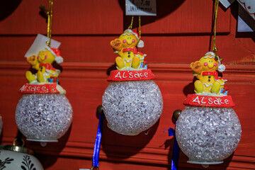 Display full of colorful Christmas ornaments and toys for sale at a souvenir shop in the old town in Colmar, France
