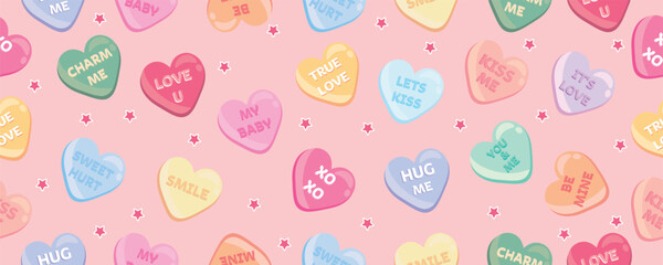 Many scattered heart-shaped candies on pink background. Valentine's Day celebration