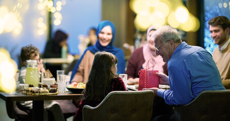 Grandparents arrive at their children's and grandchildren's gathering for iftar in a restaurant...