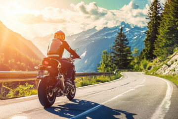 man wearing a helmet and riding a motorcycle on a winding mountain road. The sun is shining, and...