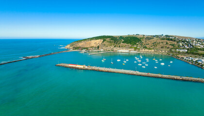 Pier and boasts in the ocean in Oamaru, Otago, New Zealand.