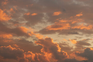 Orange Sunset background with different textures and colors in the clouds.