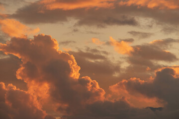 Orange Sunset background with different textures and colors in the clouds.