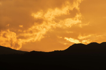Orange Sunset background with different textures and colors in the clouds.