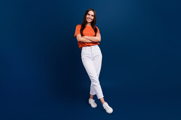 Fototapeta na wymiar Full length photo of confident adorable lady wear orange t-shirt arms crossed isolated dark blue color background