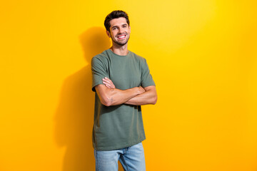 Portrait of handsome optimistic guy with stubble wear stylish t-shirt standing hold arms crossed...