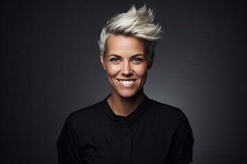 Portrait of a beautiful blond woman with short haircut on black background