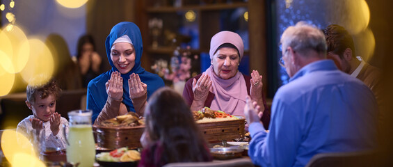 In a modern restaurant setting, a European Islamic family comes together for iftar during Ramadan,...