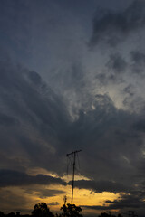 Silhouette of an antenna on the sky at sunset background.