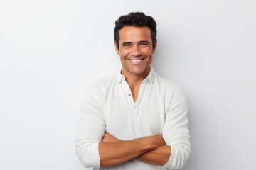 Portrait of a handsome young man smiling and looking at camera against white background
