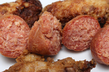 pieces of sausage with chicken wings. details of pork and chicken. meal details. meats with...