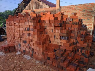 Obraz premium piles of red bricks for building materials for houses