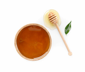 Tasty honey in bowl, dipper and green leaf on white background, flat lay
