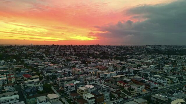 Endless cityscape of Los Angles with burning sunrise sky, aerial view
