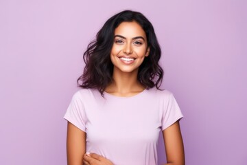 Portrait of happy smiling young woman in casual clothes, over violet background
