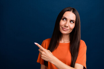 Fototapeta premium Portrait of optimistic person long hairstyle wear stylish clothes look indicating at promo empty space isolated on dark blue background