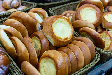 Appetizing freshly baked sweet Belarusian vatrushkas with curd cheese for sale in bakery - obrazy, fototapety, plakaty