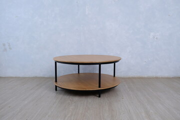 natural color teak wood round table that has black iron legs and frame. 