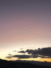 Purple sunset with orange and big clouds. Medellin, Antioquia, Colombia.