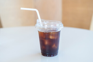 Iced coffee, A cup of iced americano coffee on the table, Plastic cup with lid and straw. Americano