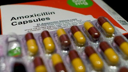 Amoxicillin Capsules - Medication Box, revealing crucial dosage information for effective healthcare management. Macro Shot, Low Angle. Dolly Left