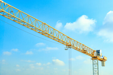 Industrial construction crane with blue sky background at building site