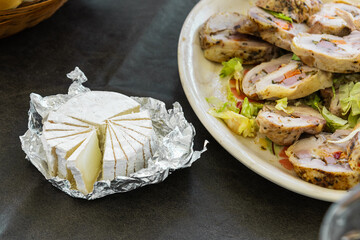 goat cheese cake divided into triangular portions on aluminum or metal foil