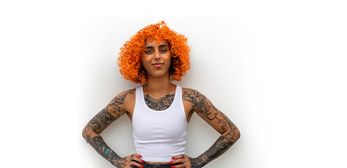 Latina Woman with Curly Orange Hair Brown Eyes Afro Wearing A White Tank Top With Tight Blue Jeans And Tattoos