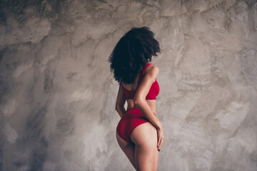 Photo portrait of attractive young pretty woman no filter pose show back figure dressed red underwear isolated on studio texture background