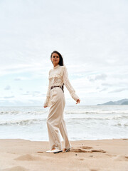 Beauty in the Summer Breeze: A Young Asian Lady Embracing Freedom and Happiness on a Beach in Thailand