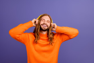 Photo of chilling hippie guy wearing yellow earphones new spotify trendy music playlist in his mind...