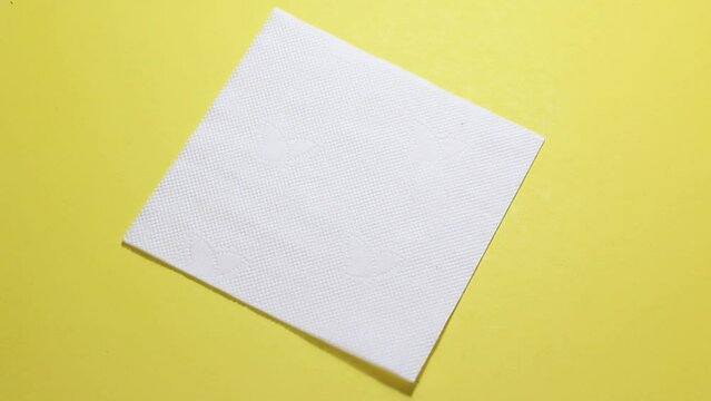 Full HD video. Greeting card for religious holiday. Handdrawn doodle line art egg on white napkin against yellow background. Happy Easter. Male hand takes real chicken egg out of drawing. Hocus pocus