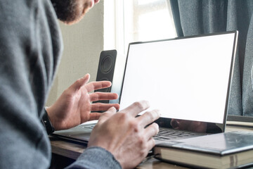 Hombre profesional trabajando en la computadora portátil desde su hogar.