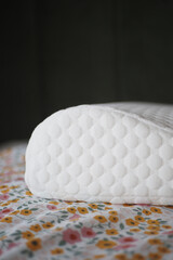 Orthopedic memory foam pillow on bed 