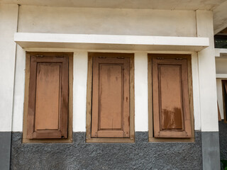 three windows without glass were painted brown and were slightly damaged