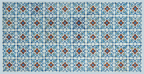 Rows of antique Nyonya Tiles with red flowers with light blue background. Vintage Baba and Nyonya style floral tile pattern in penang. Traditional Peranakan cultural in Malaysia.