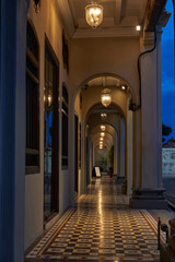 Heritage house with beautiful arches in Penang. Vintage Nanyang style house. Warm lights along the ancient corridor.