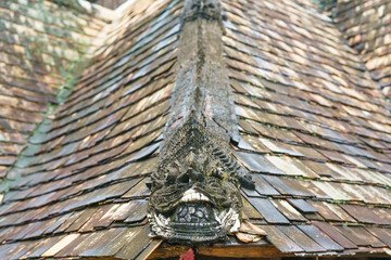 Thai Temple Roof Tiles Amidst Old House Architecture