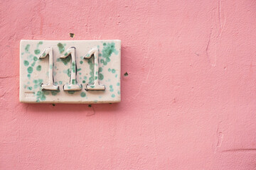  Decorative lettering on a pink color wall.