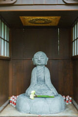 Buddha statue in a peaceful temple, surrounded by serene white stone, embodying Asian culture and spirituality