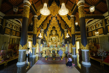 church or cathedral, featuring intricate architecture, religious symbols like Buddha statue, and vibrant stained