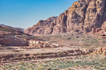 Fototapeta na wymiar Ruins of a temple over a mountainous landscape in the city of Petra, Wadi Musa, Jordan.
