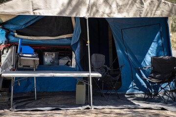 Cooking on a gas cooker at a campsite in the Forrest. Cooking outside on a blue camper trailer. Having fun in a tent in the bush in a national park in Sydney, nsw, Australia.