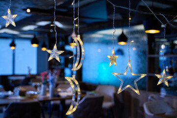 In a modern restaurant, the ambiance is transformed by the presence of sparkling Islamic symbolic...